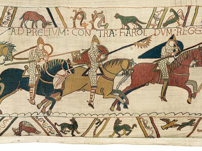 Medieval tapestry showing armored horse riders in battle, with animals and Latin text above and below the main scene.