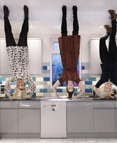 People posing in an upside down room at Liverpool's Quirky Quarter