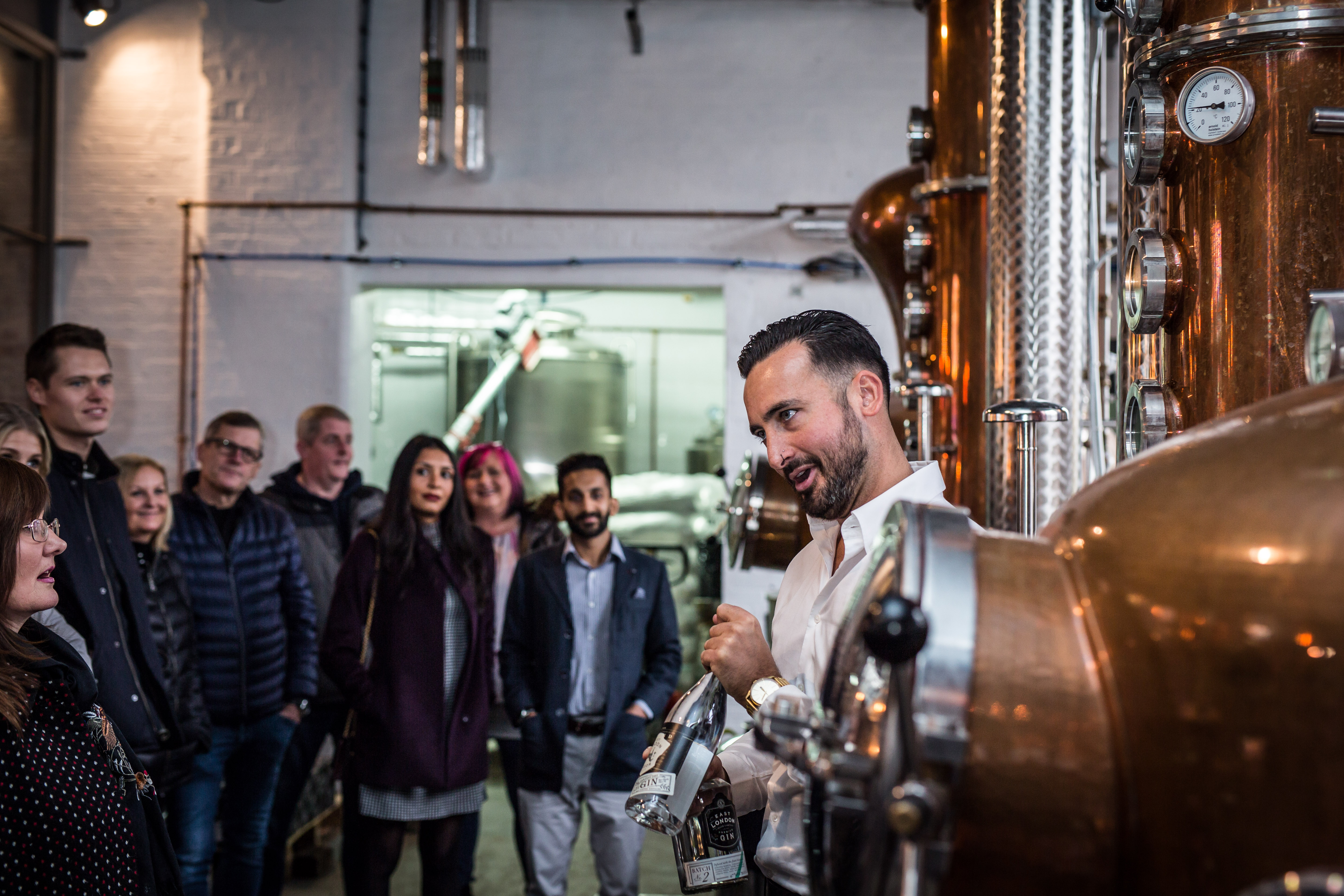 A tour group being shown around a gin distillery in Leeds