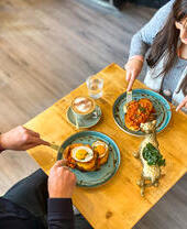 People enjoying food at a table in the Vibe Cafe in Liverpool