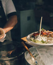 Chef che serve cibo all'Abergavenny Food Festival, Galles