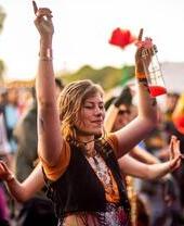 A lady dancing in the foreground at Eden Festival