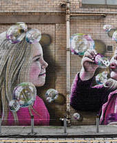 Mural on wall of kids blowing bubbles, Glasgow Mural Trail
