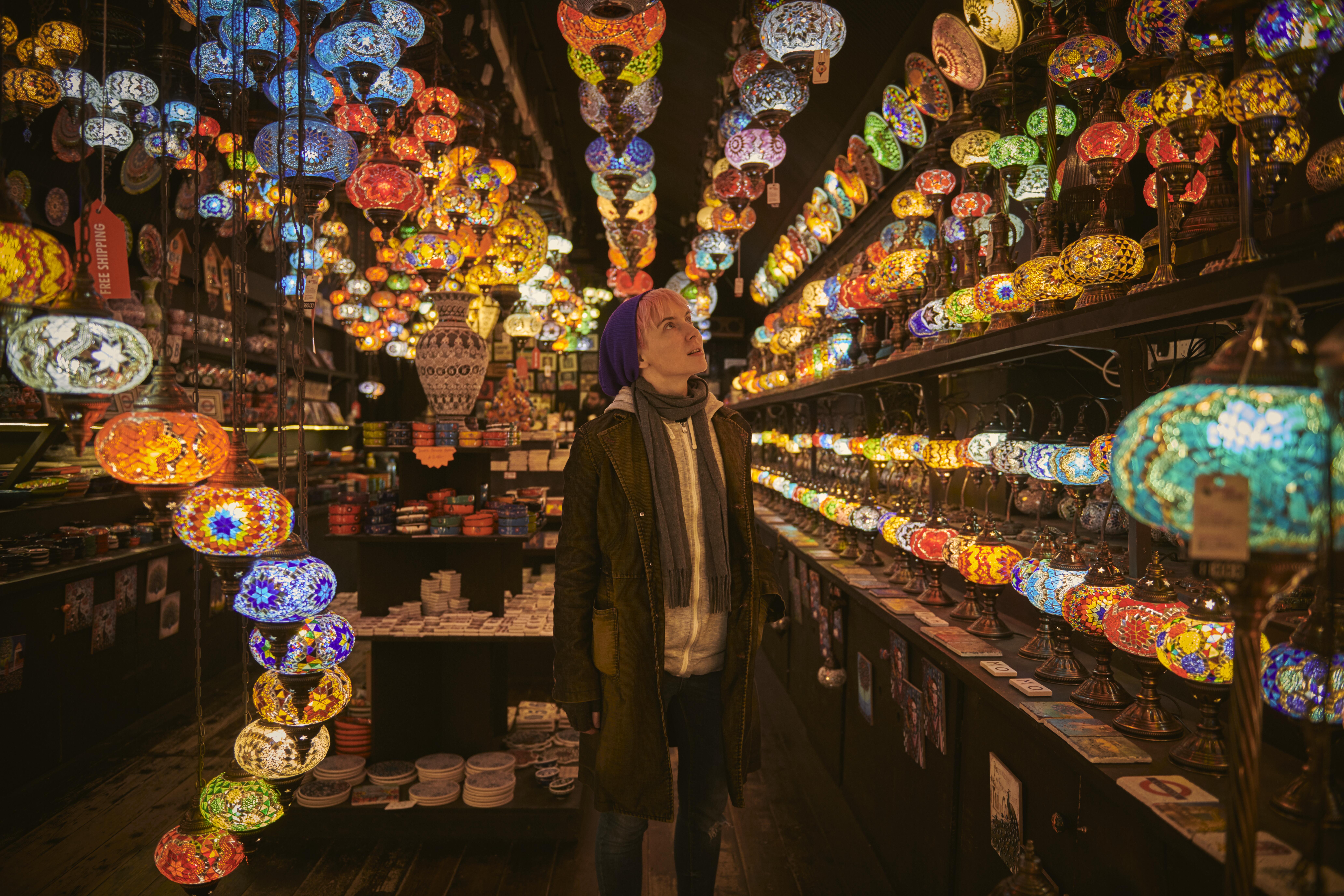 One young woman standing in a lighting shop